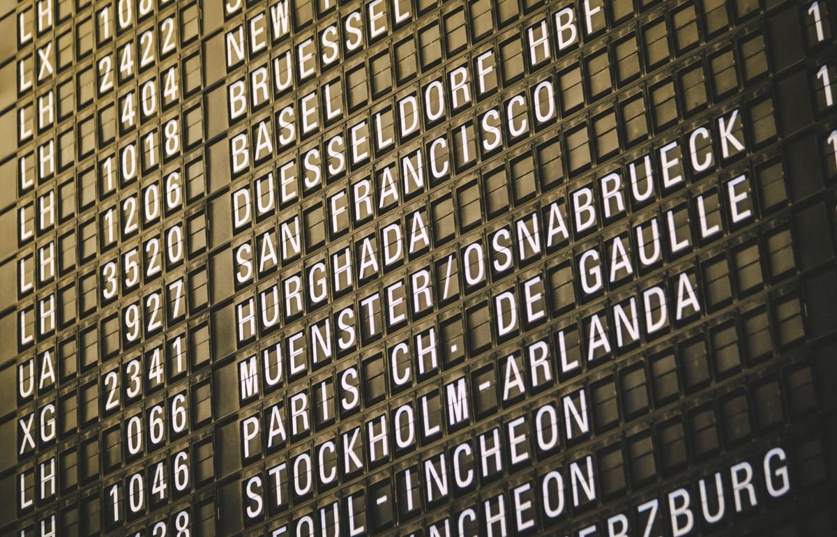 An airport departure board showing flight information