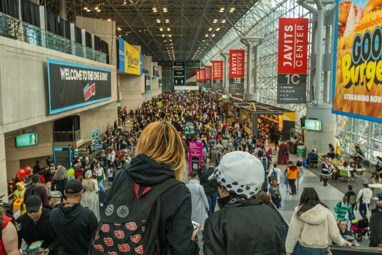 A lively crowd of fans and cosplayers at a comic convention