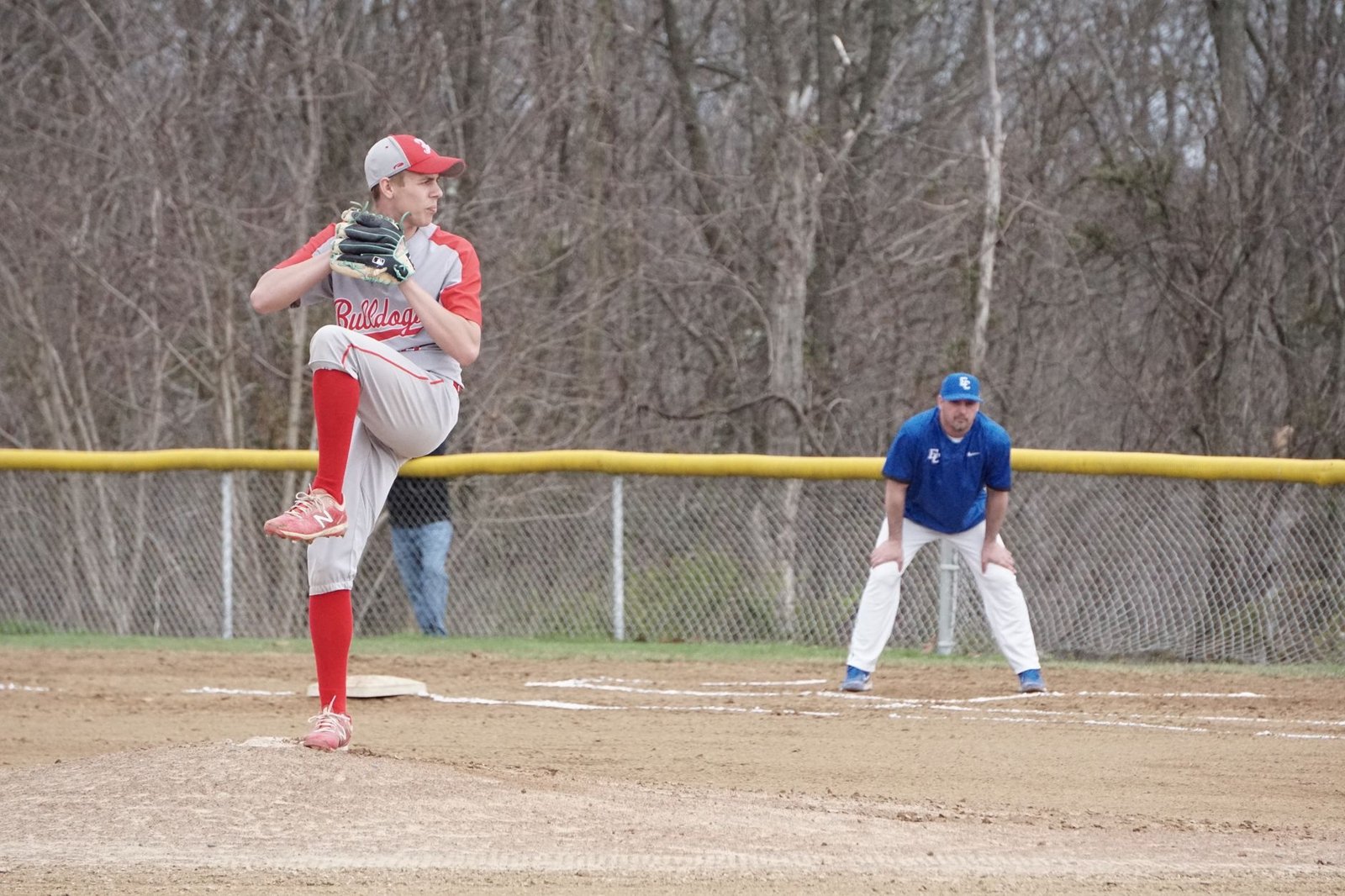 A baseball closer warming up in the bullpen before entering a high-stakes game