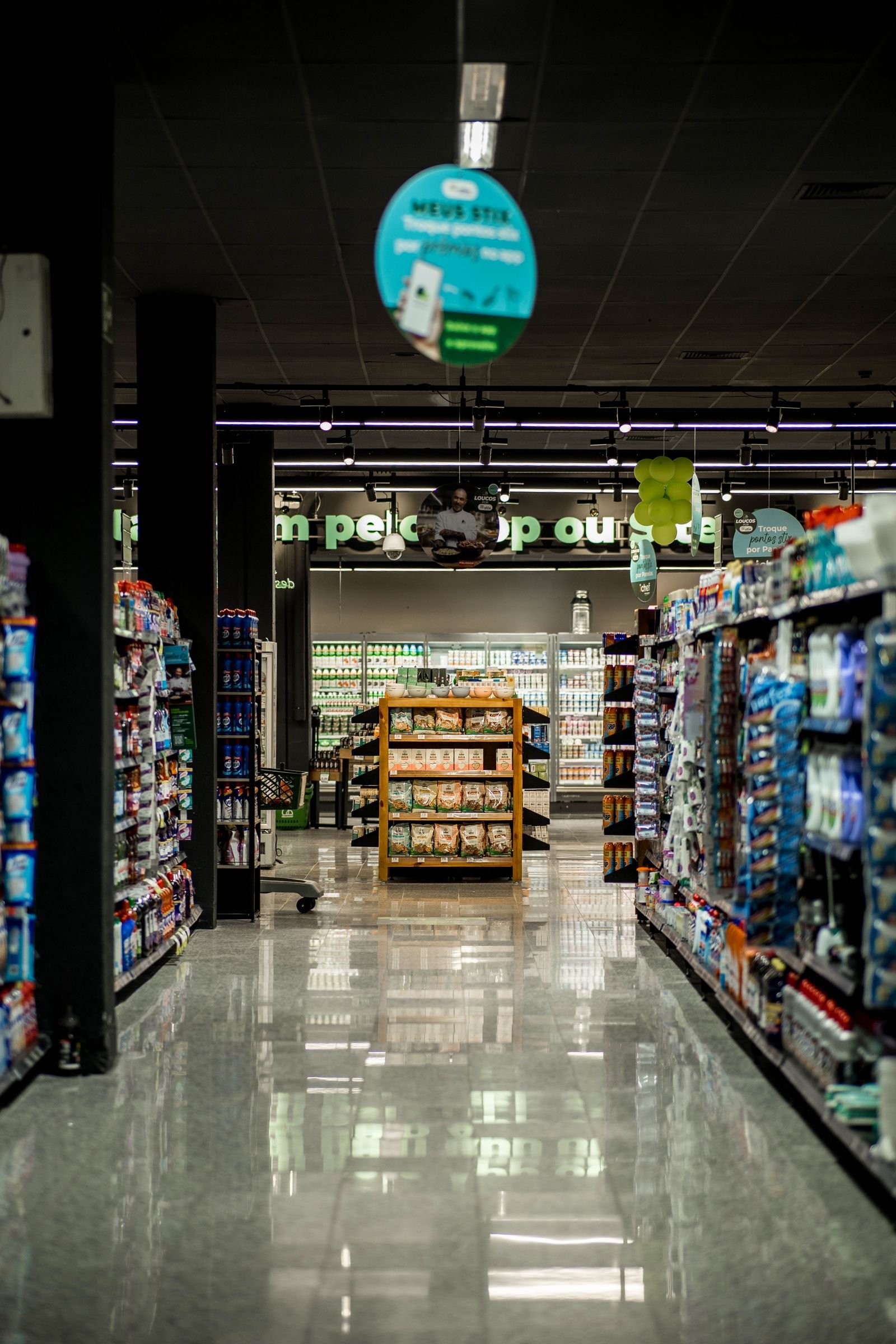 Empty, dimly lit retail store aisle after closing hours