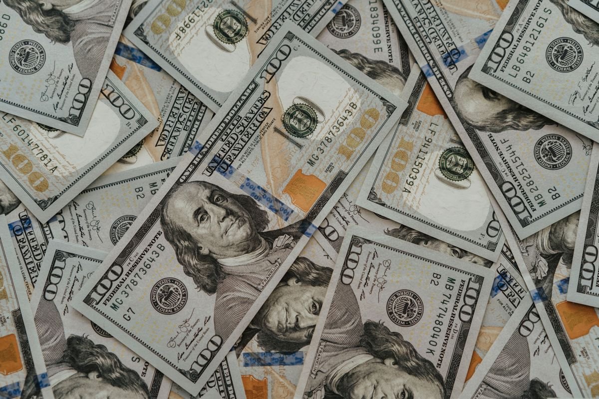 Scattered US one hundred dollar bills.