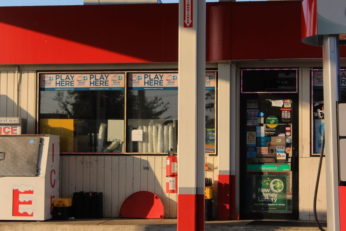 Lottery signs outside a convenience store at a gas station.