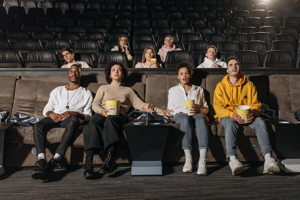 An audience reacting to a suspenseful scene in a movie theater
