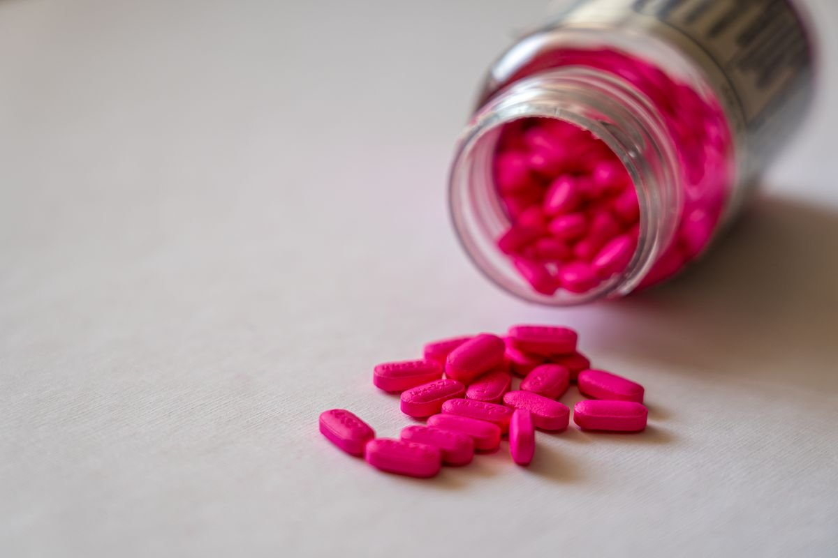 An open bottle spilling pills onto a surface