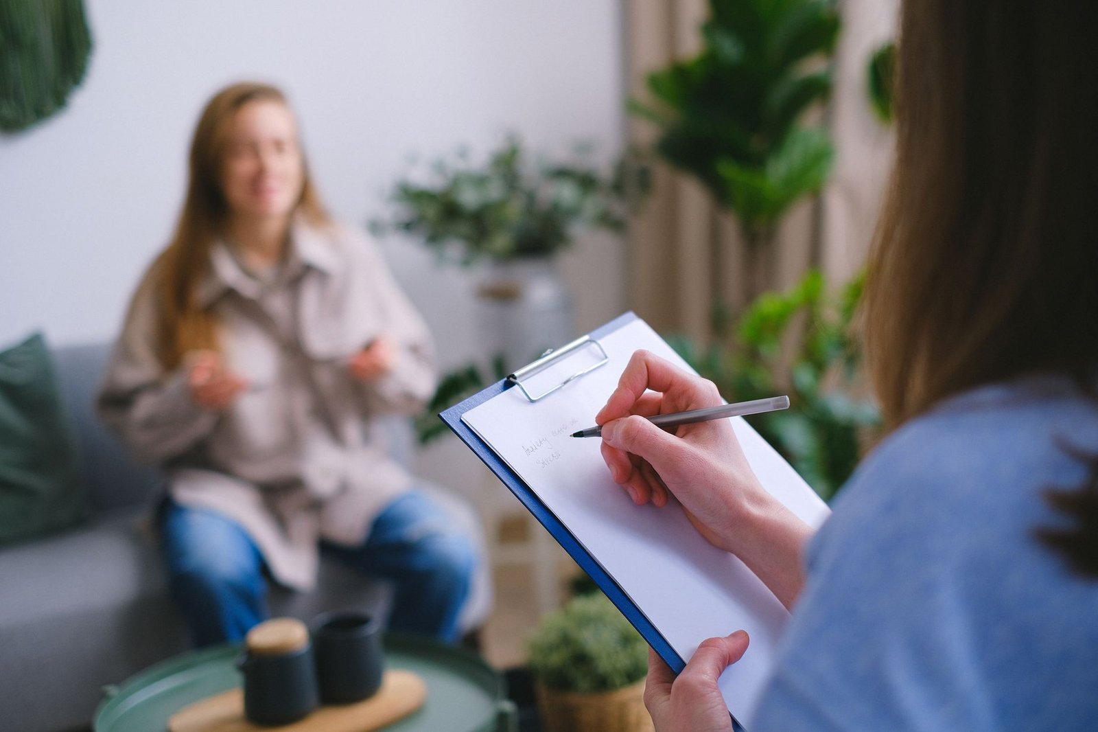 Psychiatric nurse practitioner reviewing patient notes in a clinical office setting