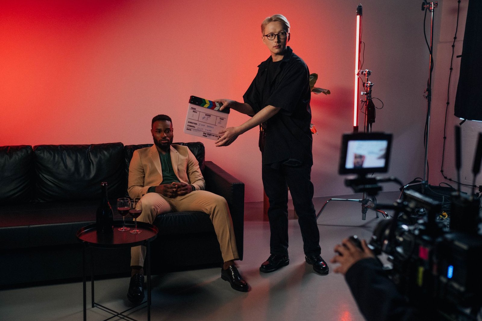 A film director and young actor reviewing a scene together on set, symbolizing mentorship across generations in Hollywood.