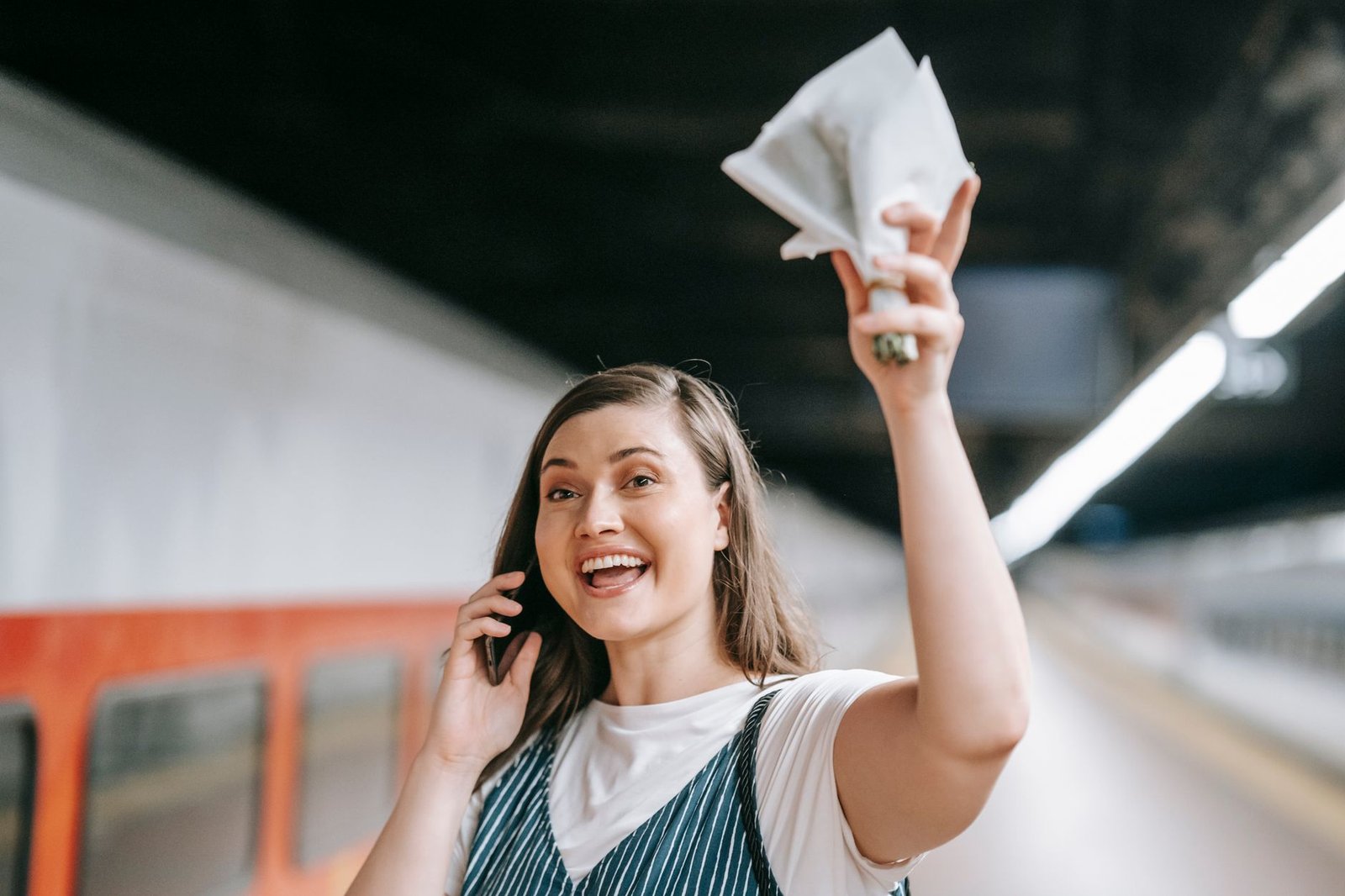 Person checking concert ticket resale prices on a smartphone outside a stadium