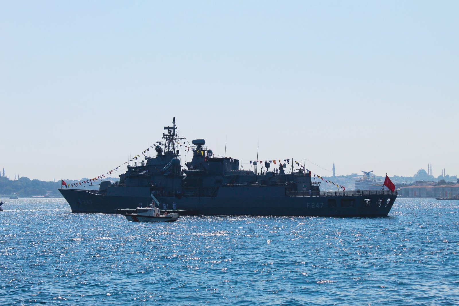 Naval vessels patrolling the Strait of Hormuz, a key global oil shipping lane.