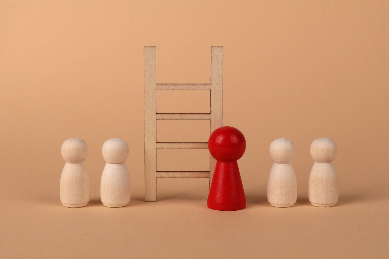 Person climbing a career ladder with a helping hand above, symbolizing nepotism and privilege in hiring