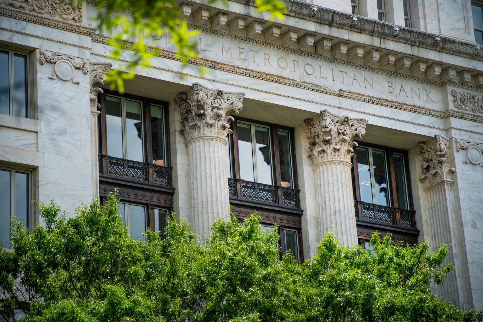 Government building with cryptocurrency symbols representing World Liberty Financial bank charter approval