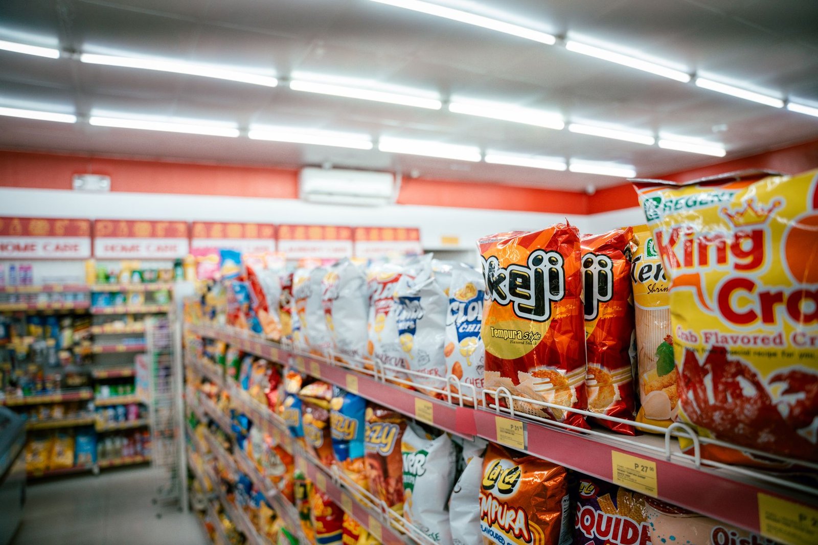 Rows of snacks and drinks inside a convenience store aisle