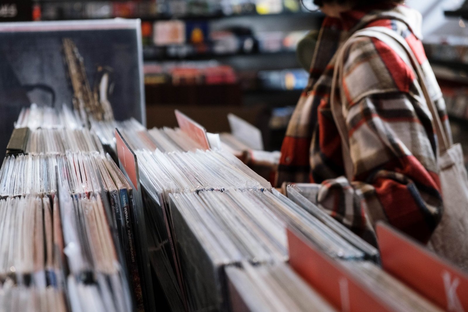 A shopper examining trading card packs on a store shelf